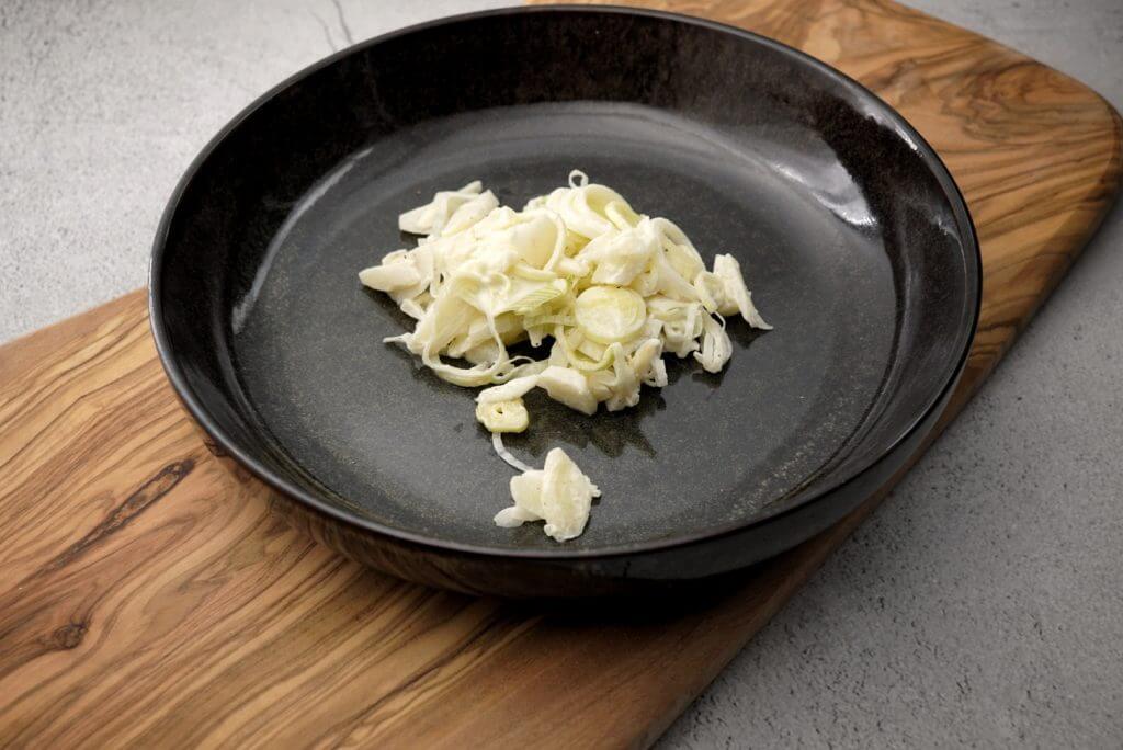 apple leek salad served on a plate.