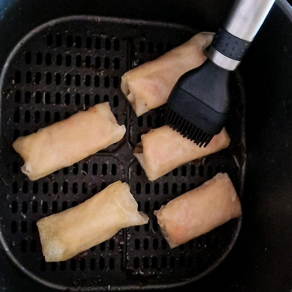 Air fryer frozen spring rolls, before frying.