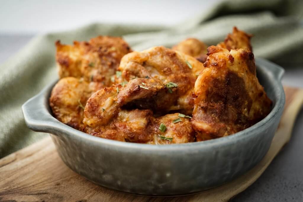 Air fryer boneless chicken thighs served on a plate.