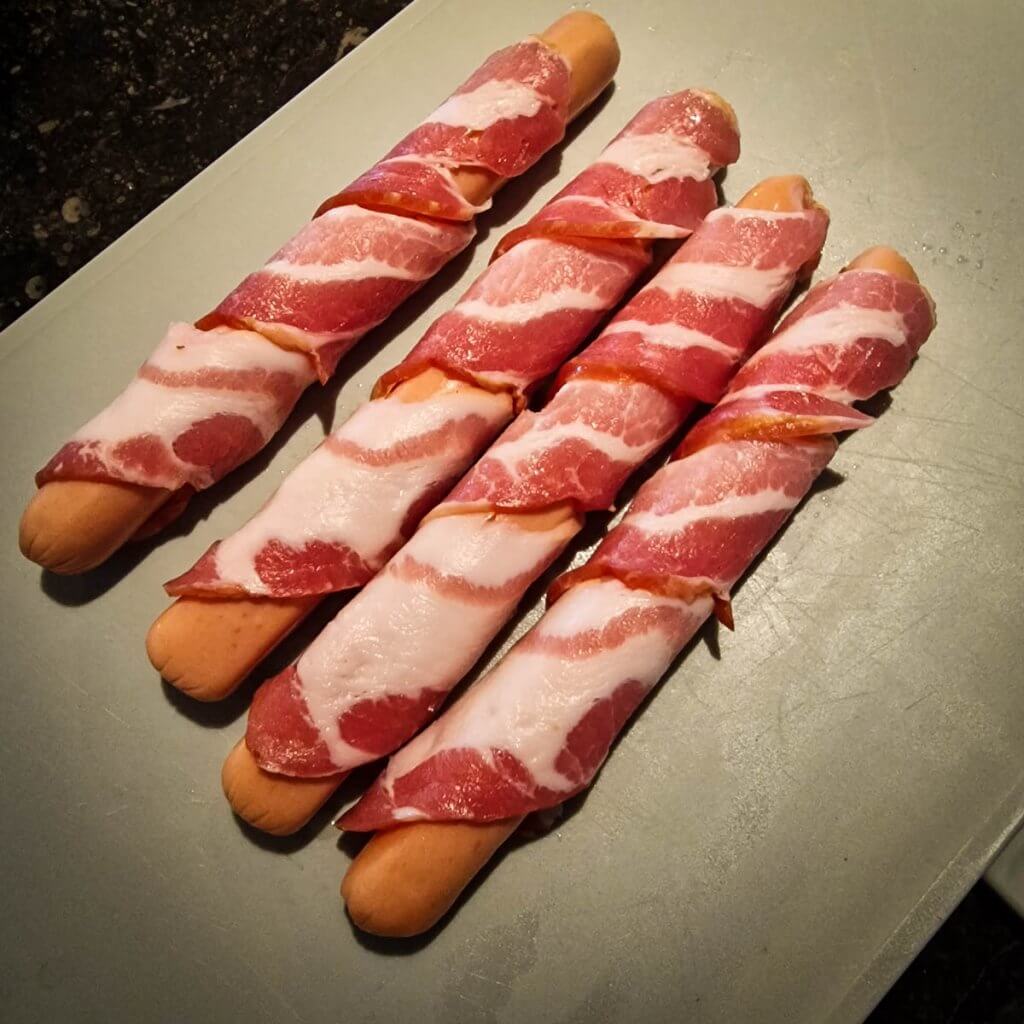 raw bacon-wrapped hot dogs.
