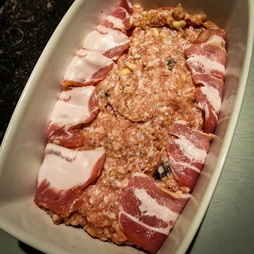 Raw bacon-wrapped meatloaf.