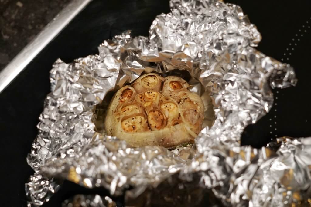 Air fryer roasted garlic in aluminum foil.